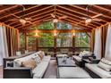 Inviting covered patio with ceiling fans, comfortable seating, and wooded view at 1109 Pine Grove Ne Ave, Brookhaven, GA 30319