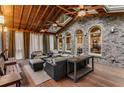 Inviting screened porch featuring a wood ceiling, brick accents, and comfortable seating arrangements at 1109 Pine Grove Ne Ave, Brookhaven, GA 30319