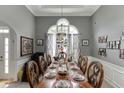 Elegant dining room with an ornate chandelier and wainscoting at 1258 Rocky Branch Trl, Lawrenceville, GA 30043