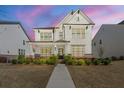 Beautifully landscaped front yard with manicured bushes leading to this home's entry at 241 3Rd Ave, Avondale Estates, GA 30002