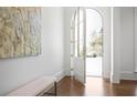 Bright foyer featuring hardwood floors, arched doorway, and natural light, with a decorative painting at 3364 Knollwood Nw Dr, Atlanta, GA 30305