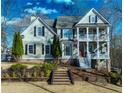 Charming two-story home featuring a double front porch and well-maintained landscaping at 7492 Shadburn Ferry Rd, Cumming, GA 30041