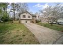 Split level home with neutral siding and an attached two-car garage at 1517 Cherry Hill Sw Rd, Conyers, GA 30094