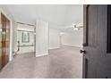 Inviting entryway showcasing neutral colors and carpet, leading to other areas of this well-maintained home at 235 Shallowford Nw Rd, Kennesaw, GA 30144