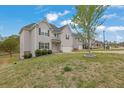 Well-maintained home featuring a spacious lawn, a two-car garage, and professionally landscaped grounds at 3945 Hamilton Cove Ct, Cumming, GA 30028
