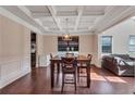 Elegant dining room featuring coffered ceiling, and hardwood floors at 1606 Kenilworth Se Ln, Conyers, GA 30013