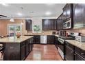 Well-equipped kitchen with stainless steel appliances, granite countertops, and dark cabinets at 1606 Kenilworth Se Ln, Conyers, GA 30013