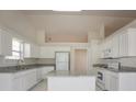 Well-lit kitchen with white cabinetry, granite countertops, stainless steel appliances, and an island at 1056 Fern Valley Way, Dacula, GA 30019