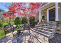 Cozy stone patio with seating and landscaped front yard at 1287 University Ne Dr, Atlanta, GA 30306