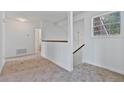 Upstairs hallway with neutral carpet, white walls and stairs access at 2209 N Forest Trl, Dunwoody, GA 30338