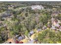 A high-angle aerial view of the neighborhood and tree-lined property at 1135 Parkview Sw Way, Lilburn, GA 30047