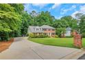 Attractive two-story brick home with a spacious, well-maintained lawn and long driveway at 1135 Parkview Sw Way, Lilburn, GA 30047