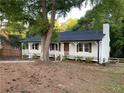 Traditional-style home with an inviting front porch, chimney, and well-maintained lawn at 1110 Toonigh Rd, Canton, GA 30115