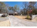 Beautiful home with a long driveway, a manicured lawn, and a traditional white picket fence at 116 Myrtle Rd, Woodstock, GA 30189