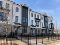 Well-maintained townhome exteriors boasting brick accents, black trim, and gated front yards at 633 Silva St # 133, Cumming, GA 30040