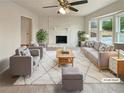 Bright, staged living room featuring a stone fireplace, bay window, and neutral furnishings at 1336 Candlelite Ln, Snellville, GA 30078