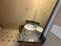 Modest bathroom featuring a black countertop, sink and mirror at 2863 Windsor Forrest Ct, Atlanta, GA 30349