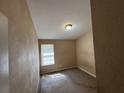 Small bedroom with carpet, window and simple ceiling light at 2863 Windsor Forrest Ct, Atlanta, GA 30349