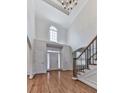 Spacious foyer with hardwood floors, high ceilings, and a staircase, leading to a bright and welcoming entryway at 3891 Greensward Nw Vw, Kennesaw, GA 30144