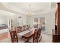 Formal dining room with elegant chandelier and a large table for eight at 4370 Landover Way, Suwanee, GA 30024