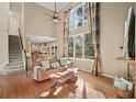 Open-concept living room featuring hardwood floors, high ceilings and staircase at 4370 Landover Way, Suwanee, GA 30024