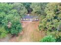 Overhead view of home nestled among mature trees and large grassy yard at 105 Simonton (Tract 1) Se Rd, Lawrenceville, GA 30046