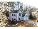 Charming two-story home featuring a two-car garage, well-manicured lawn, and classic architectural details at 10715 Glenbarr Dr, Johns Creek, GA 30097