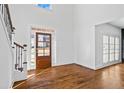 Inviting entryway with hardwood floors, shiplap accent wall, and natural light shining through the front door at 2130 Waters Ferry Dr, Lawrenceville, GA 30043