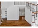 Bright entryway with hardwood floors, white walls, staircase, and a view into other rooms at 2130 Waters Ferry Dr, Lawrenceville, GA 30043