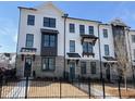 New townhomes with painted brick, black trim and black metal fence at 623 Silva St # 130, Cumming, GA 30040