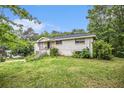 A one-story brick house featuring a well-maintained lawn and lush greenery at 8600 Andy Mountain Ct, Villa Rica, GA 30180