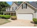 Close-up of a two-story house with an attached garage and meticulously maintained landscaping at 4315 Summit Heights Dr, Snellville, GA 30039