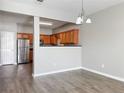 Open dining area featuring hardwood floors, a chandelier, and light gray walls at 1455 Riverrock Ct, Riverdale, GA 30296