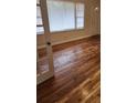Living room with hardwood floors, open windows, and natural light; entry door is visible at 2368 Jernigan Se Pl, Atlanta, GA 30315