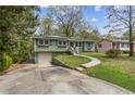 A charming single-Gathering home features a front lawn and a convenient driveway leading to a one-car garage at 2610 Crestdale Se Cir, Atlanta, GA 30316