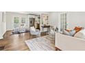 An open-concept living room features a dining area, hardwood floors, and natural light from the backyard doors at 2610 Crestdale Se Cir, Atlanta, GA 30316
