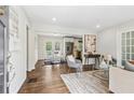 An open-concept living room features a dining area, hardwood floors, and natural light from the backyard doors at 2610 Crestdale Se Cir, Atlanta, GA 30316