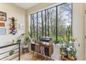 Bright living space featuring a large window with views of trees, plus a turntable and decor creating a cozy ambiance at 307 Cherokee Se Ave # 3, Atlanta, GA 30312
