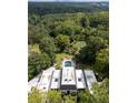 Aerial view of a sprawling estate featuring a pool, lush landscaping, and scenic views of the surrounding area at 3900 Randall Ridge Nw Rd, Atlanta, GA 30327