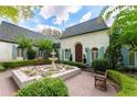 Stunning home with a brick facade, a serene fountain, and beautifully manicured landscaping at 3900 Randall Ridge Nw Rd, Atlanta, GA 30327