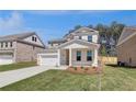 Attractive home with a two-car garage, front lawn, and well-kept landscaping at 624 Leafy Branch Way, Mcdonough, GA 30253
