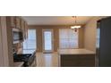 Well-lit kitchen featuring a gas range, stainless steel appliances, neutral cabinets and countertops at 5763 Dexters Mill Pl, Buford, GA 30518