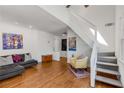 Inviting living room featuring hardwood floors, a staircase, and stylish decor at 1078 Piedmont Ne Ave # 203, Atlanta, GA 30309