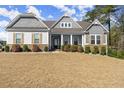 Attractive home with welcoming porch, stone accents, shutters, and well-manicured lawn at 125 Whitman Grv, Fayetteville, GA 30215