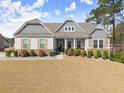 Beautiful home with stone accents, shutters, covered porch, and a well-kept lawn at 125 Whitman Grv, Fayetteville, GA 30215