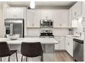 Bright kitchen featuring stainless steel appliances, a subway tile backsplash, and ample counter space at 2030 Main Nw St # 207, Atlanta, GA 30318