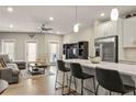 Open-concept living space with modern furnishings, a ceiling fan, and a large island with barstool seating at 2030 Main Nw St # 207, Atlanta, GA 30318
