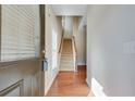 Entryway featuring hardwood floors, carpeted staircase, and neutral wall colors, creating an inviting space at 2271 Oakland Downs Way, Lawrenceville, GA 30044