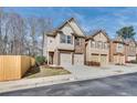 View of a row of two-story homes, each with a two-car garage and well-maintained landscaping at 2271 Oakland Downs Way, Lawrenceville, GA 30044