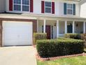 Charming townhome featuring a well-kept front yard, covered entry, and attached one-car garage at 7229 Georges Way, Morrow, GA 30260